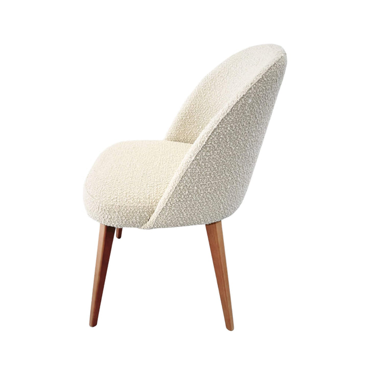 Side view of Cord Gracia dining chair highlighting curved backrest and wooden legs
