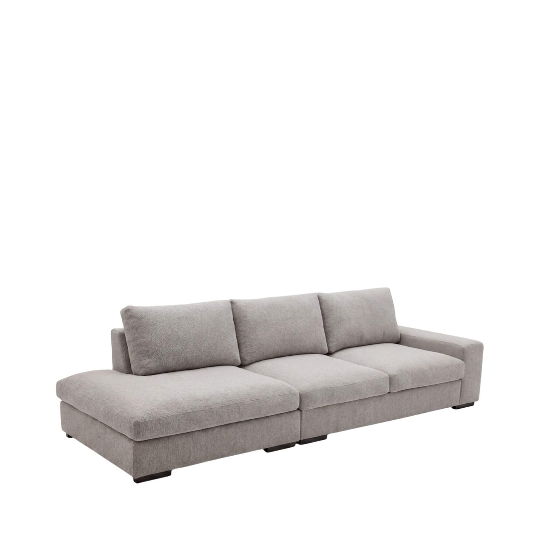 Front view of the Corfu sofa showing its wide low-profile design and soft neutral upholstery.
