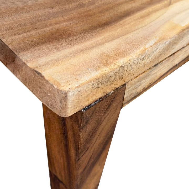 Close-up detail of the chair seat and leg joinery showing the natural suar wood grain.