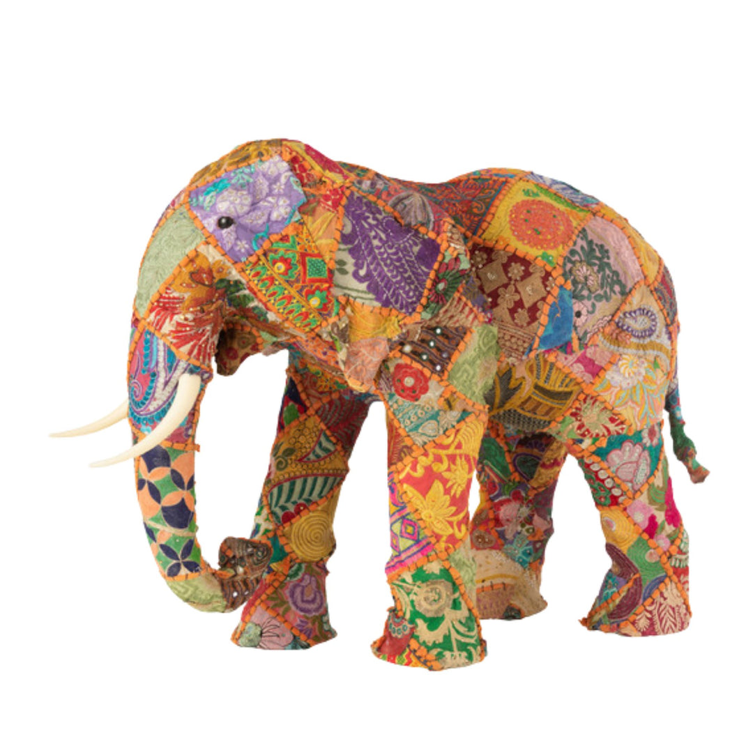 Front view of Cotton Patches Elephant with multicolor cotton patchwork and raised trunk.
