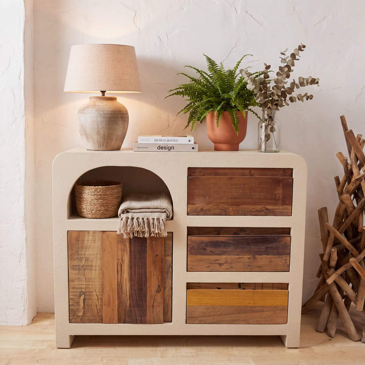 Creta buffet styled with decorative objects and a table lamp in a warm Mediterranean interior