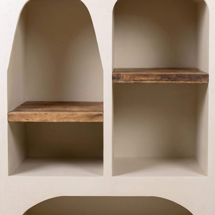 Close-up of the arched shelf section showing the cement texture and wood shelf detail.