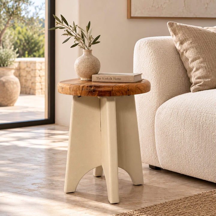Creta cement and recycled wood side table styled beside a neutral sofa in a warm Mediterranean-inspired interior