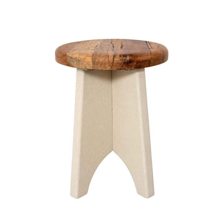Front view of the Creta side table showing its round wooden top and sculptural three-part cement base