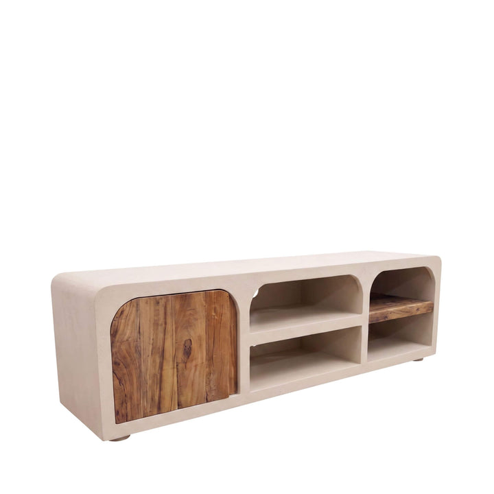 Angled view of the Creta TV console showing its rounded cement structure, wooden cabinet door, and open shelves