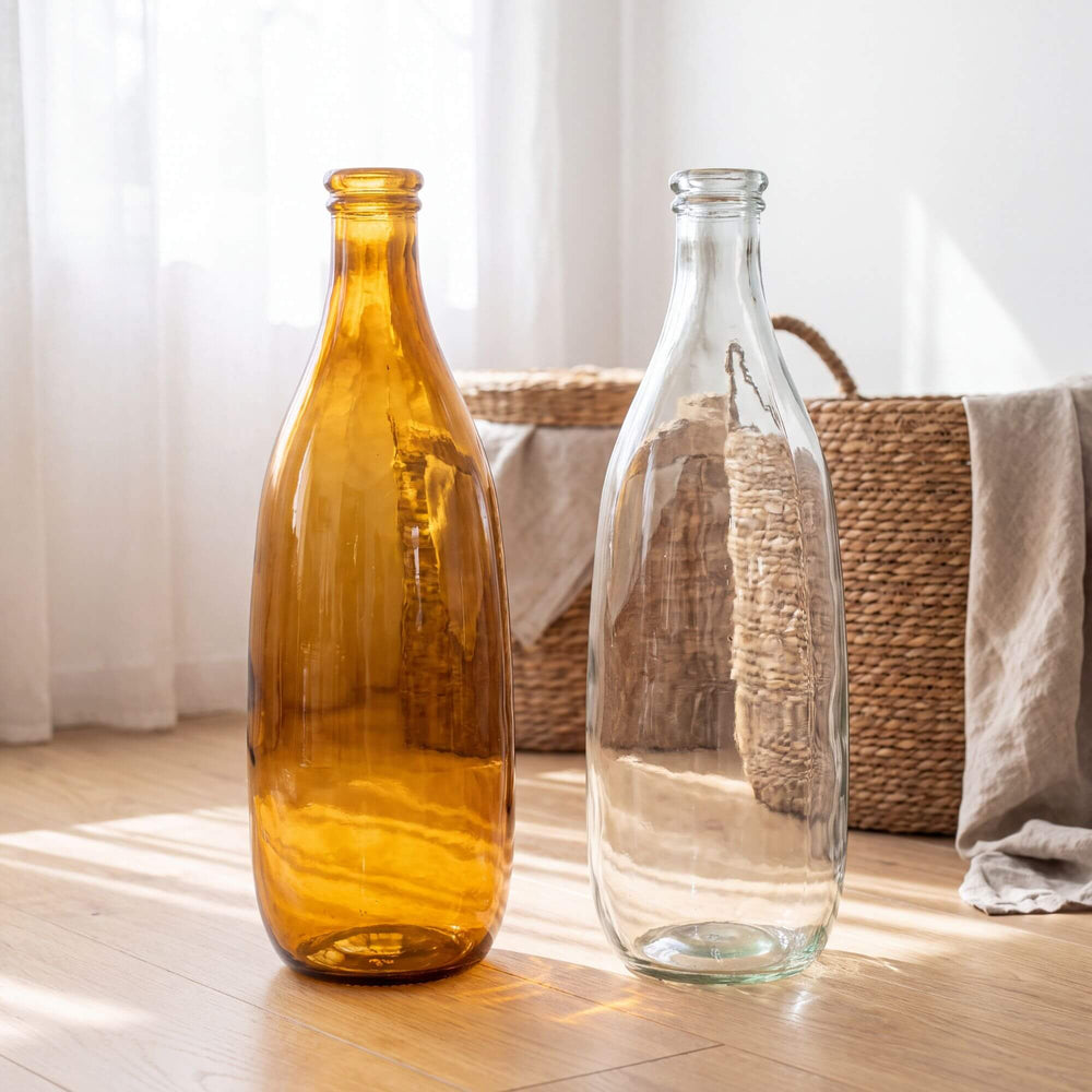 Cristallo Brown glass vase styled beside a clear glass vase in a bright natural interior