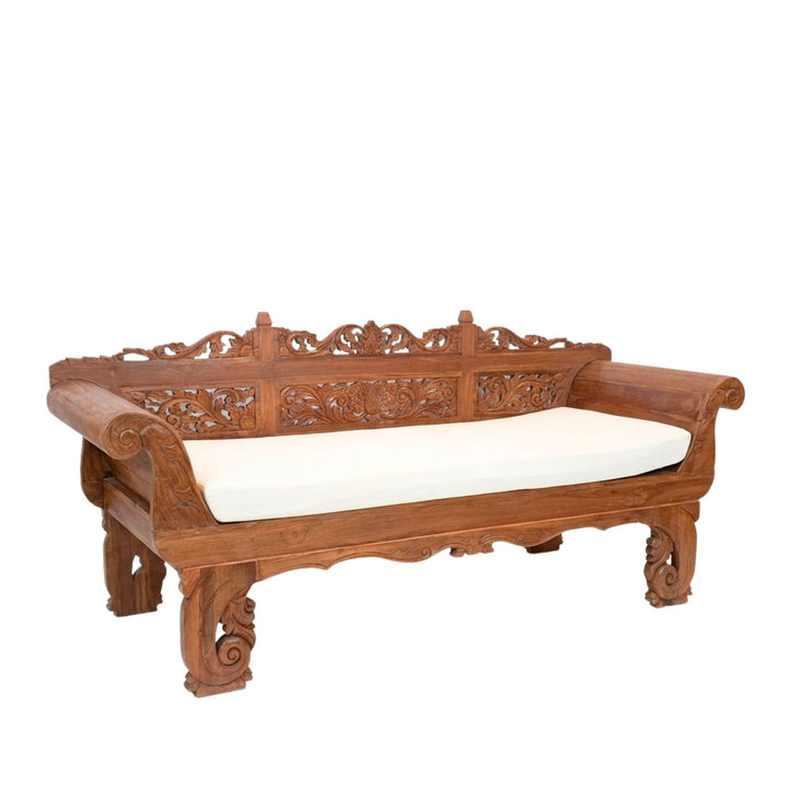 Angled view of Cronus Carved Teak Wood Daybed showcasing its hand-carved backrest and solid teak frame.