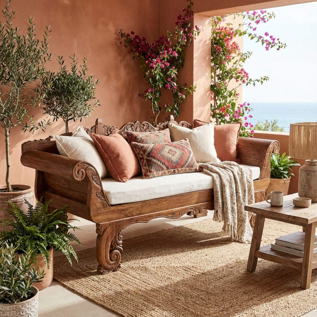 Styled terrace setting featuring the Cronus daybed with cushions, highlighting its artisanal design.