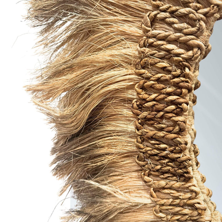 Close-up of Cendana Mirror round design with natural fiber frame in earthy tones, handmade and available in two sizes.