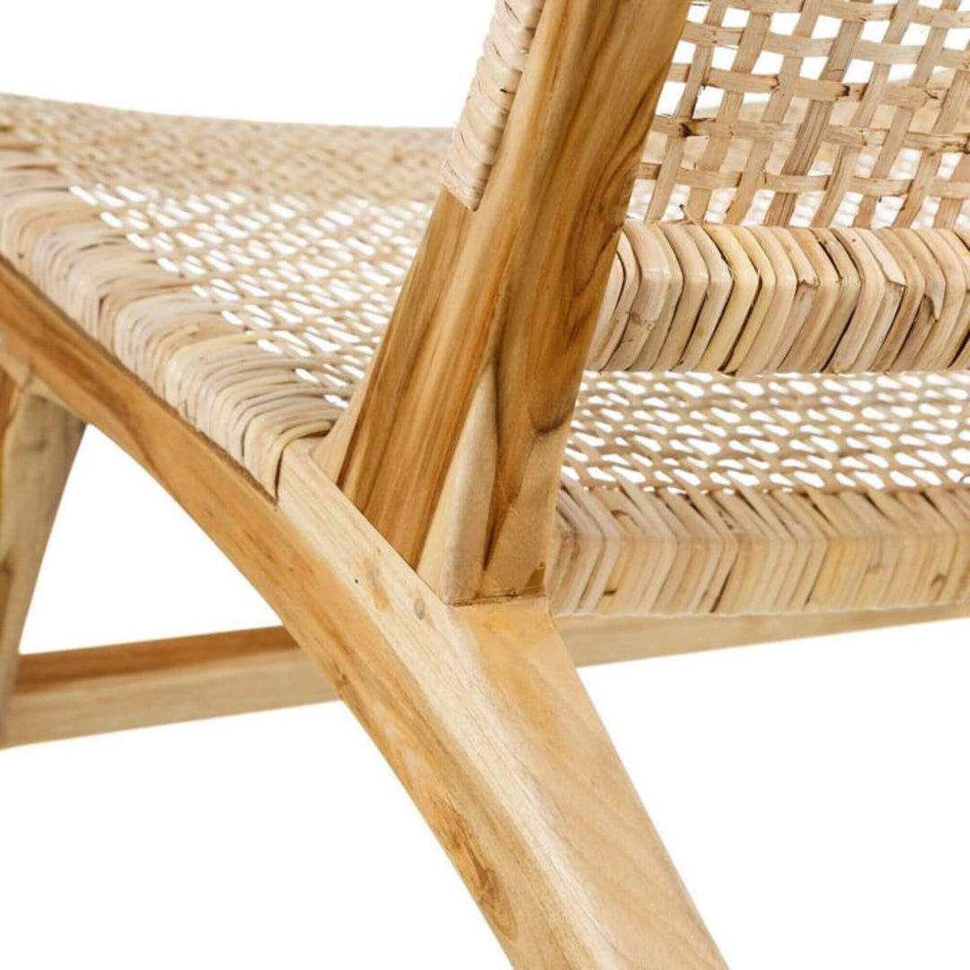 Close-up of teak wood frame and rattan seat detail on Dane lounge chair