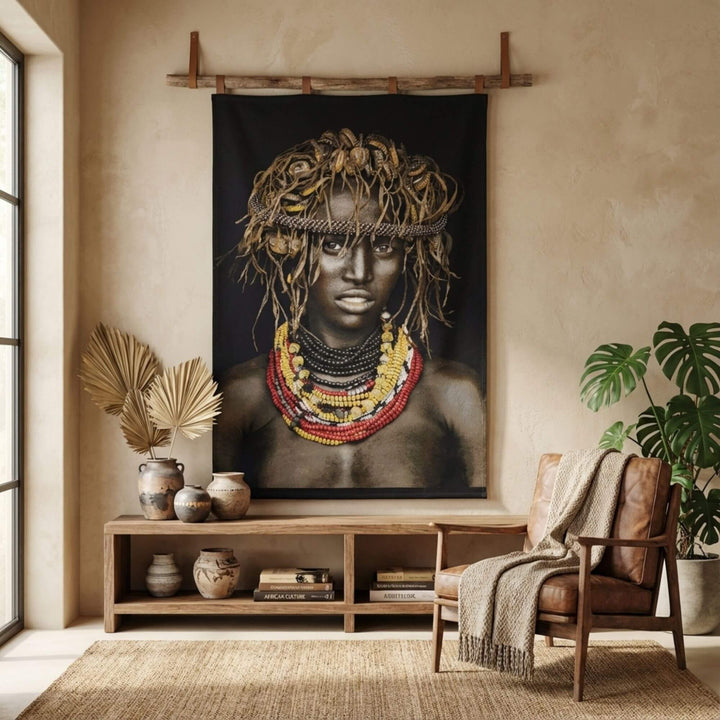 Interior styling scene showcasing the Dassanech Girl tapestry as a statement wall hanging in a warm living space.