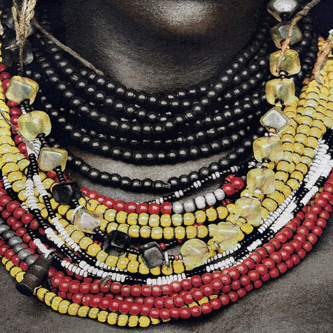 Close-up detail of the vibrant beadwork and textured fabric of the Dassanech Girl tapestry.