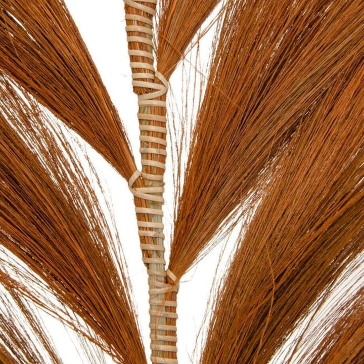Close-up of natural fiber detailing on orange decorative palm