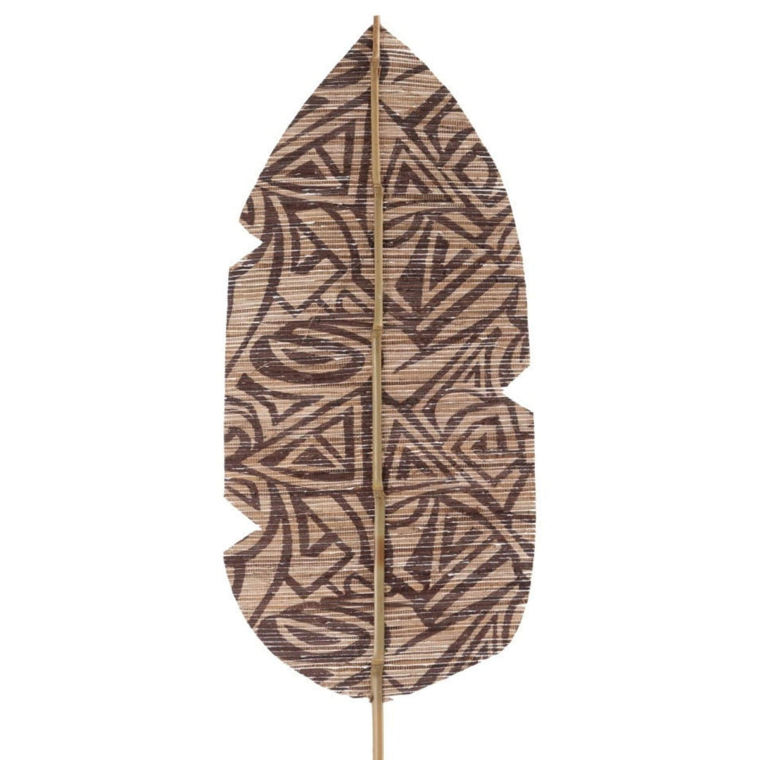 Close-up of hand-applied geometric pattern on palm leaf surface
