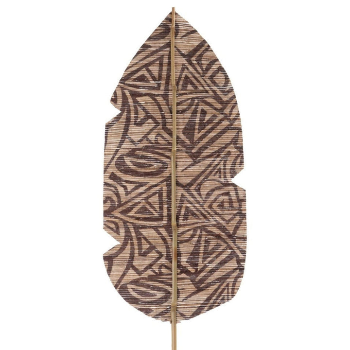 Close-up of hand-applied geometric pattern on palm leaf surface