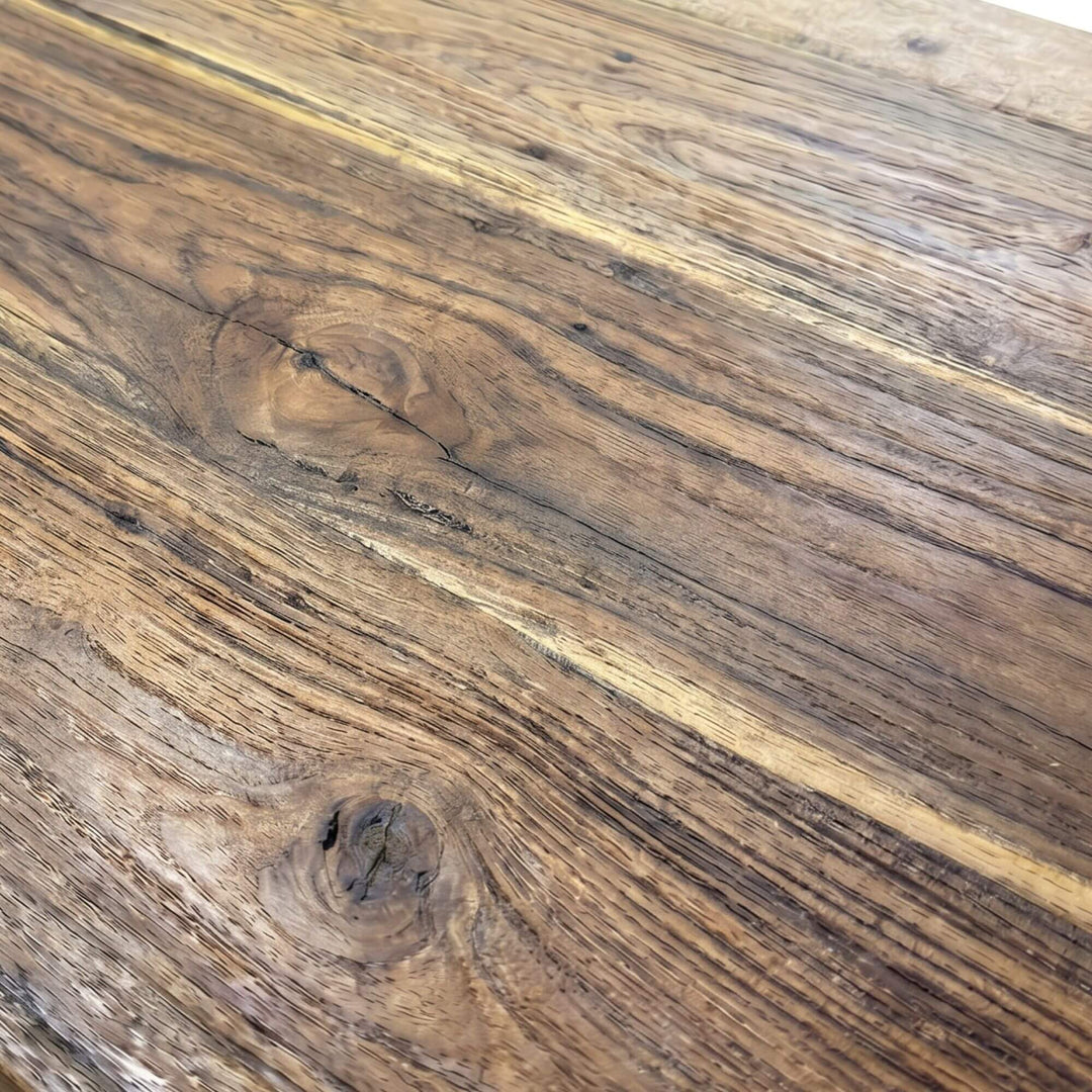 Close-up of the teak wood surface showing the natural grain and warm tone variation.