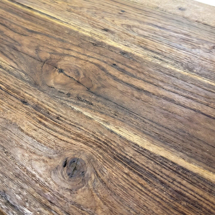 Close-up of the teak wood surface showing the natural grain and warm tone variation.