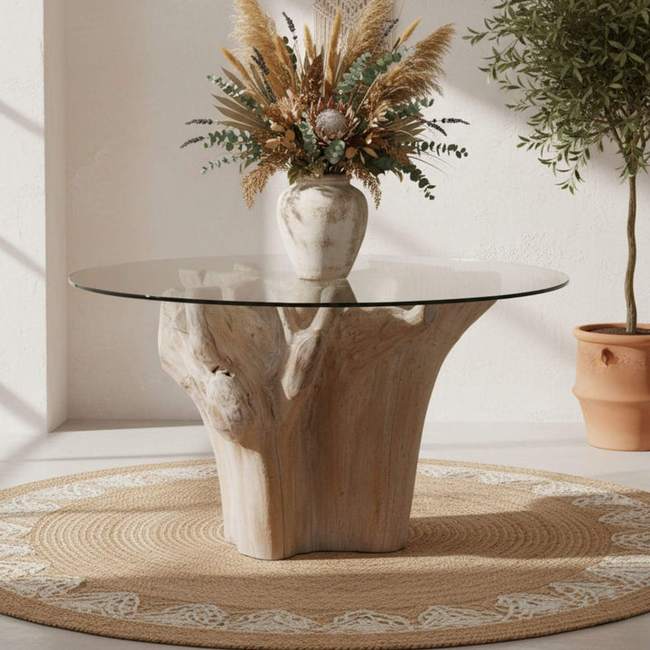 Front view of the Denpasar Dining Table with natural teak root base and round glass top.