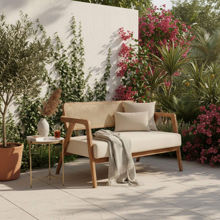 Outdoor setting featuring the Desiderium teak wood and rattan sofa.