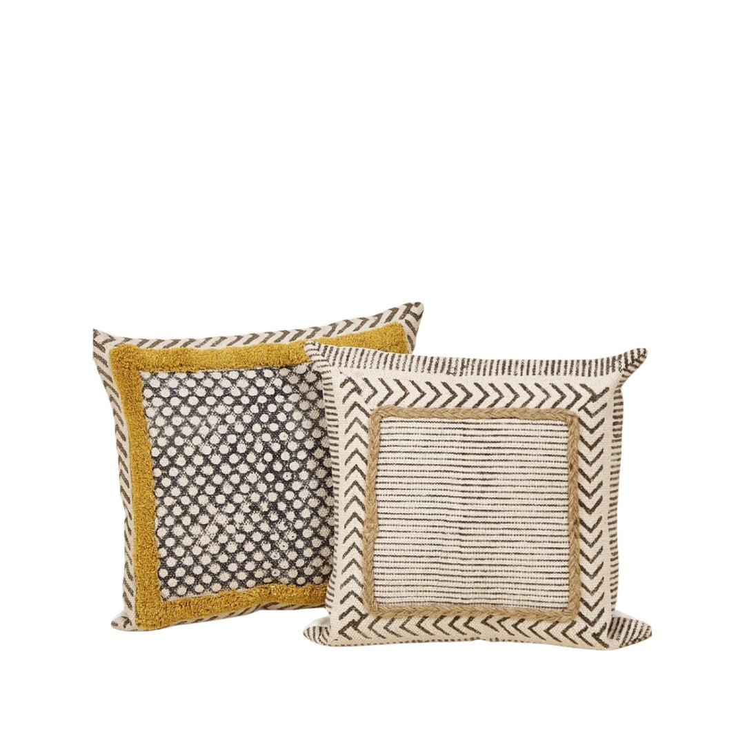 Dhara cotton cushions styled together showing mixed textures, stripes, and earthy patterns