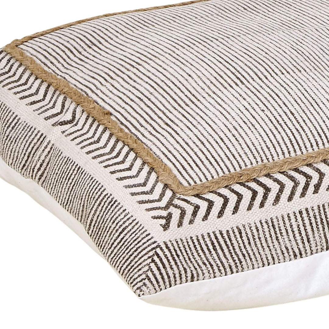 Dhara cotton floor cushion close-up with black stripe pattern and jute piping on natural fabric