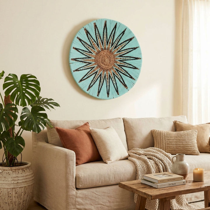 Decorative Diani wall deco plate art above a sofa in a living room with a plant and coffee table.