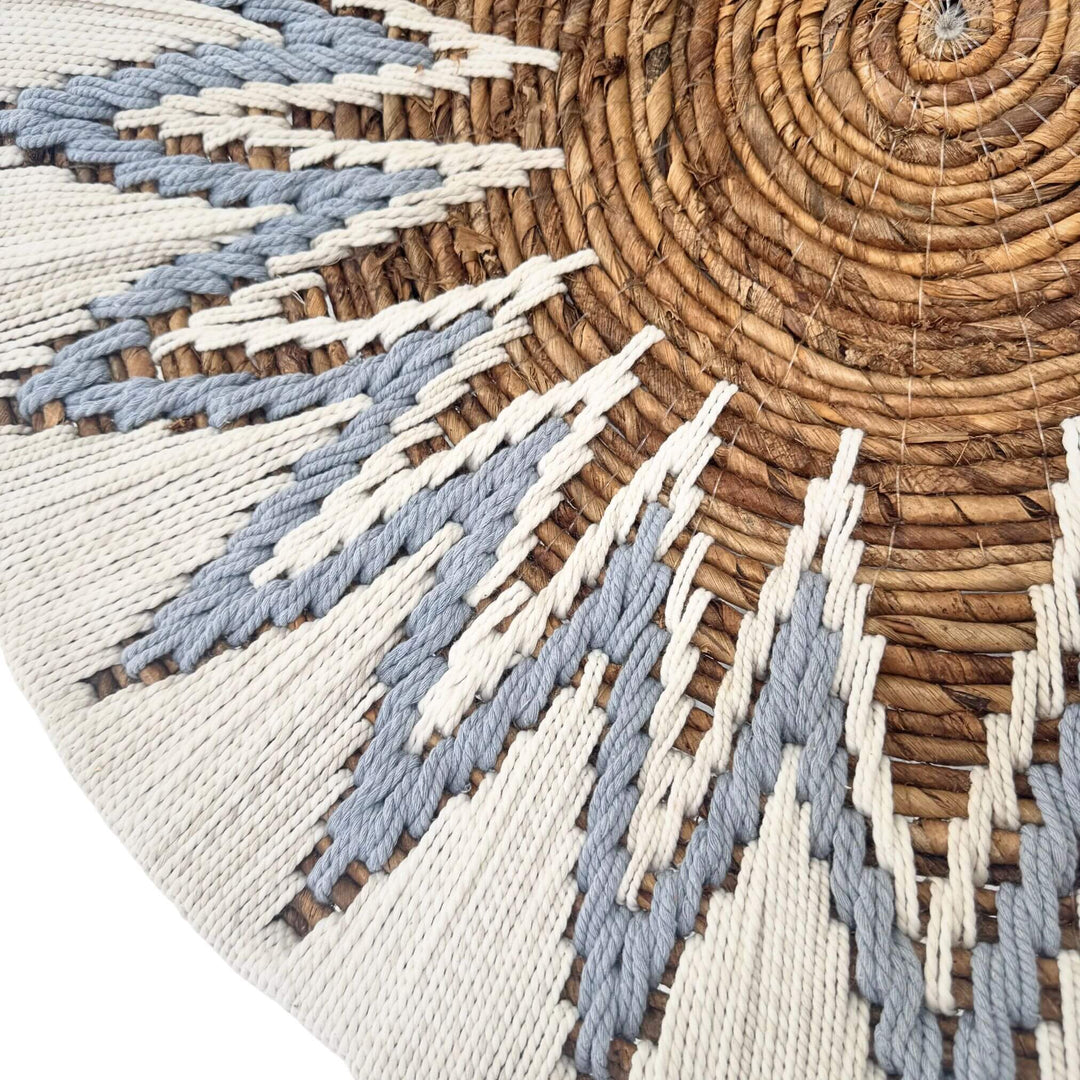 Close-up of Diani Wall Deco Plate in white and blue with starburst design made of banana fiber and cotton.
