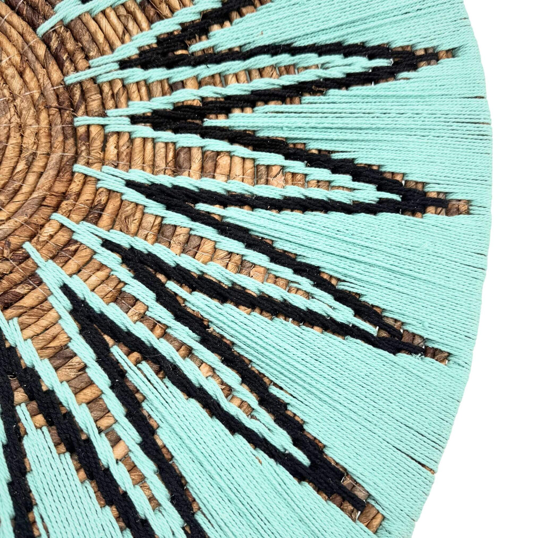 Close-up detail of Diani Wall Deco showing woven banana fibers and cotton in turquoise and black