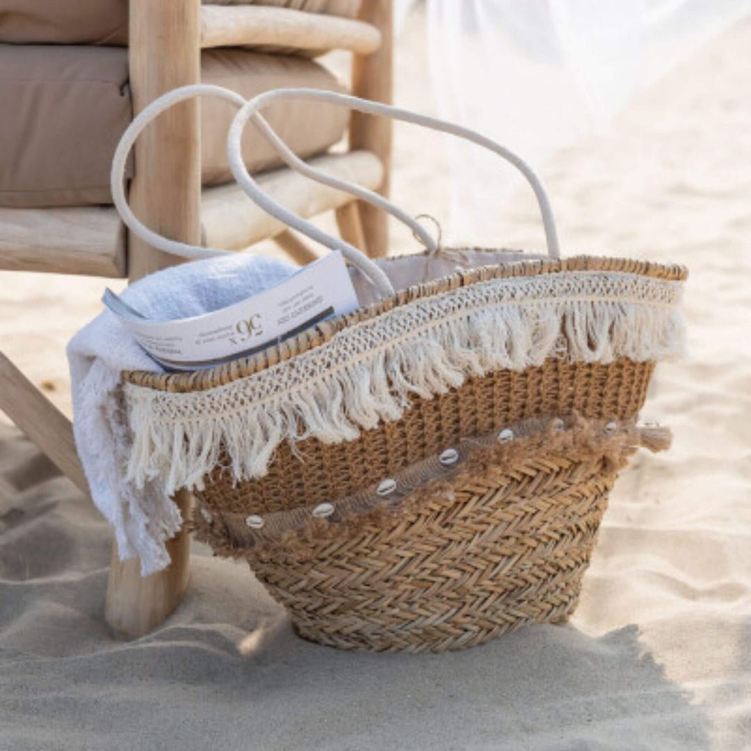 Dogon Jute Basket placed in a coastal interior setting with woven texture and white details.

