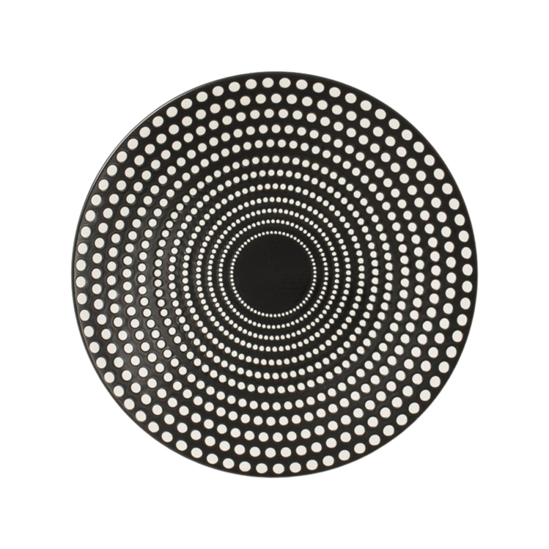Top view of black ceramic plate featuring concentric dotted design.