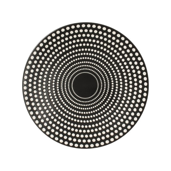 Top view of black ceramic plate featuring concentric dotted design.