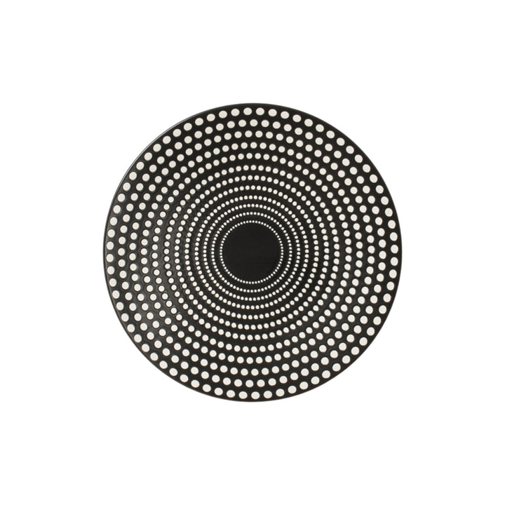Top view of black ceramic dessert plate featuring concentric dotted design.