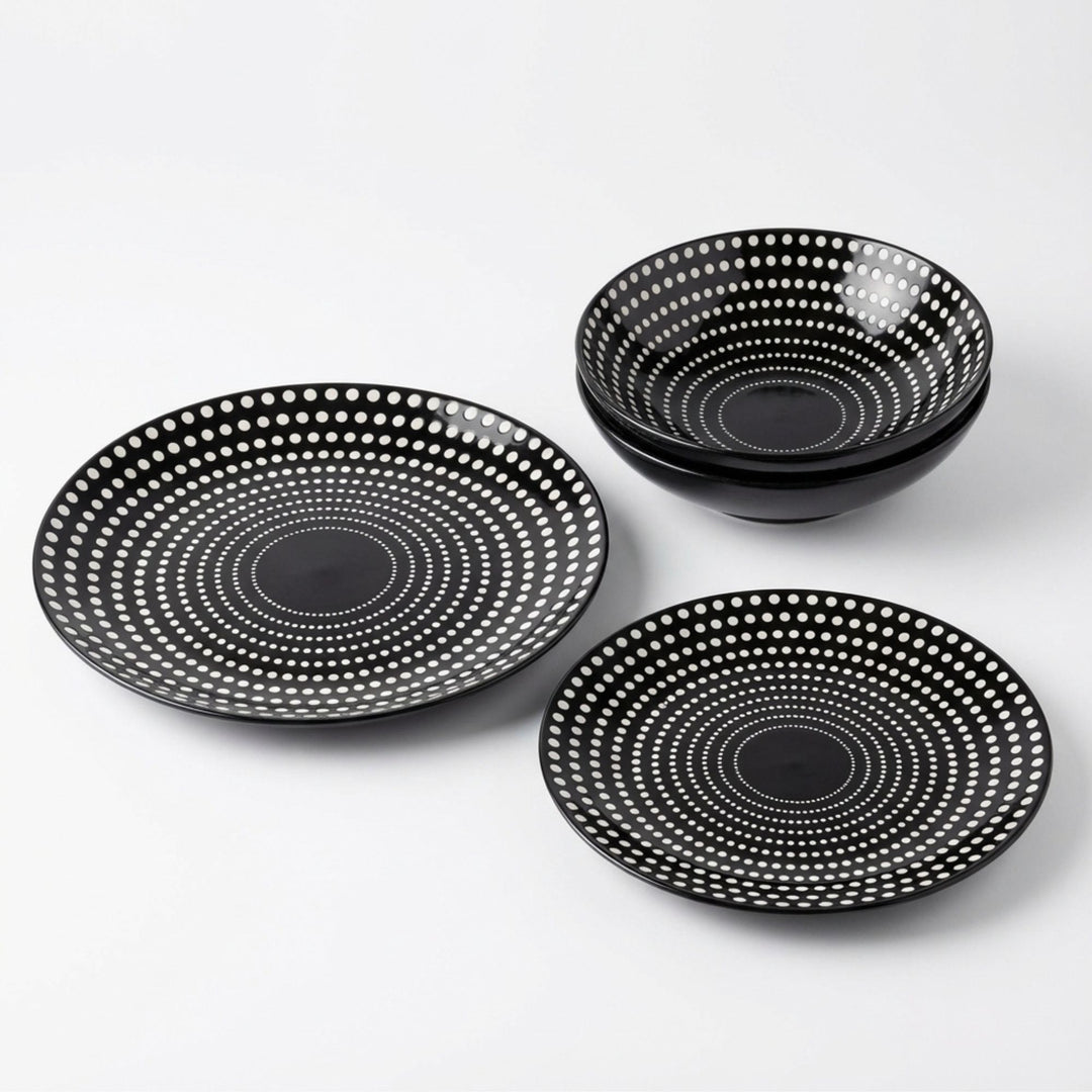 Set of Dots ceramic tableware with black base and white dotted pattern on white background.