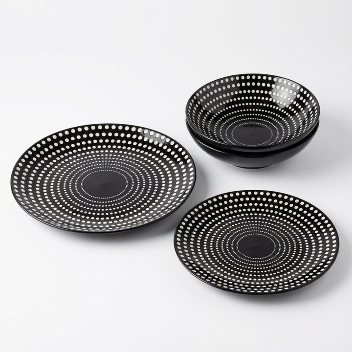 Set of Dots ceramic tableware with black base and white dotted pattern on white background.
