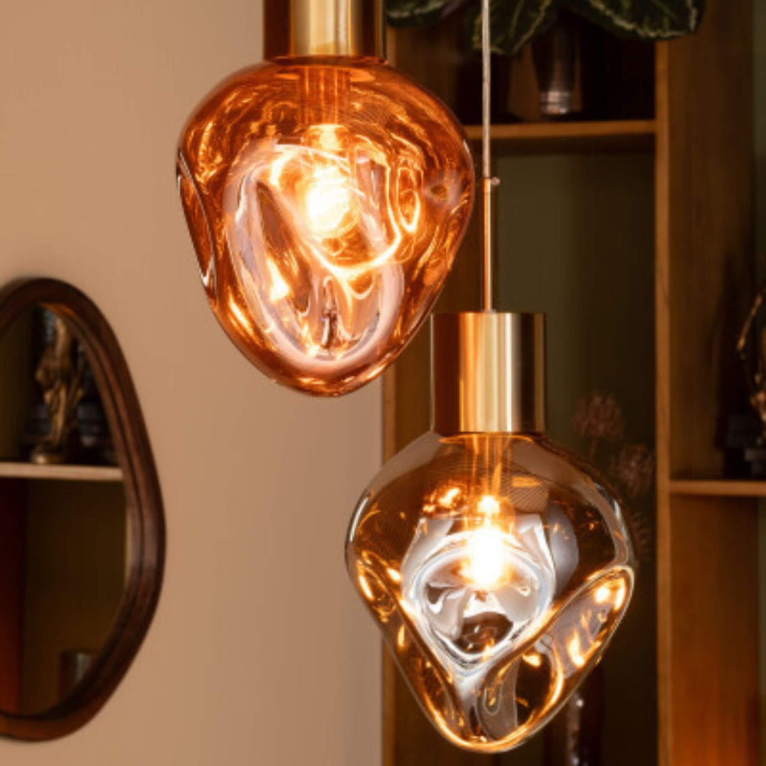 Close-up of the copper glass surface highlighting organic curves and reflective finish.