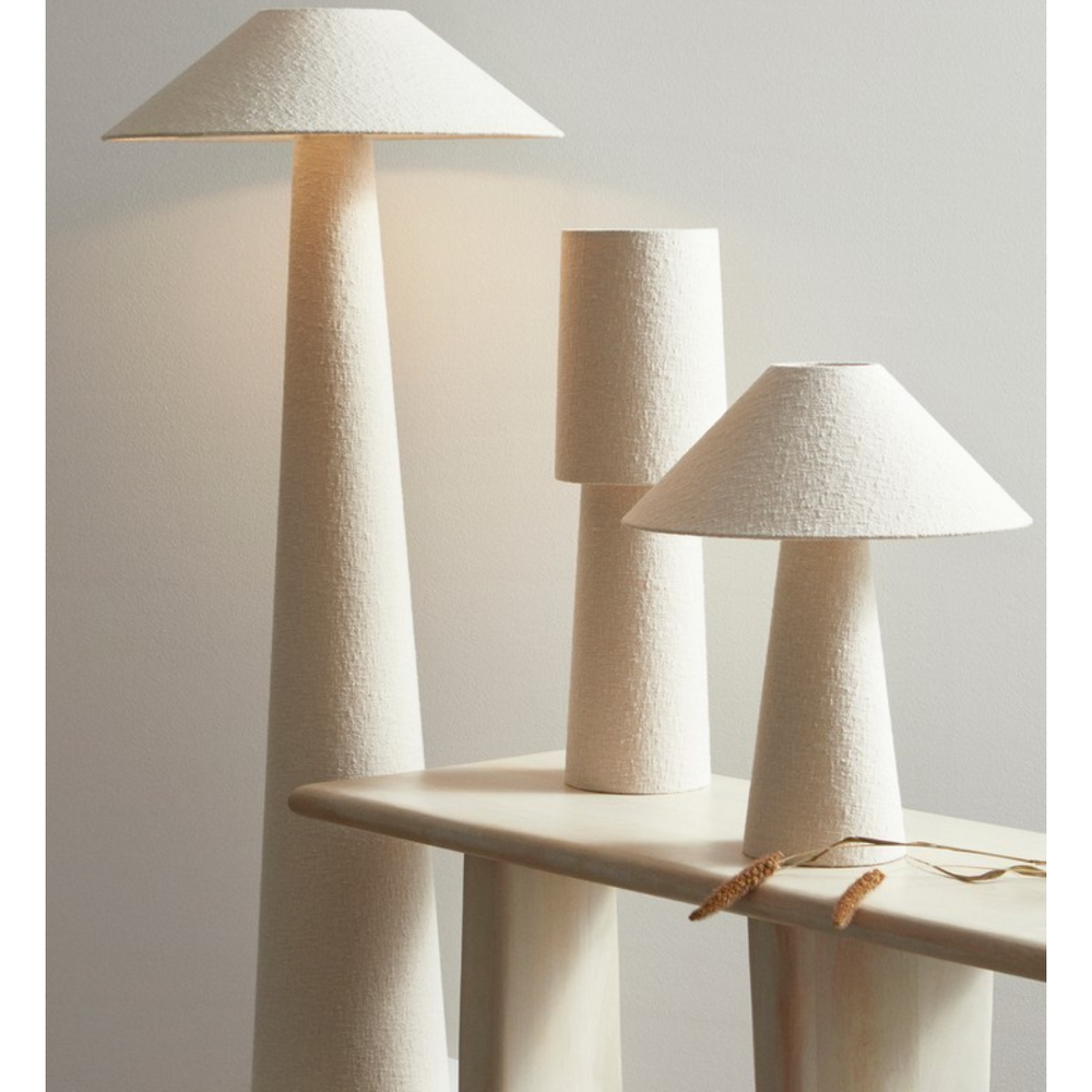 Interior view of Duna lamps in different sizes styled on a console shelf.