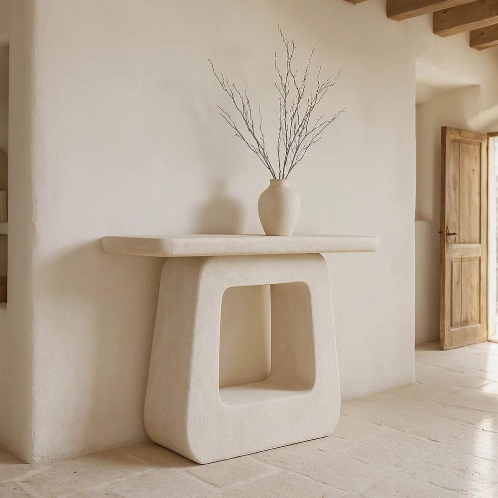 Console styled in an interior with vase decor on top.