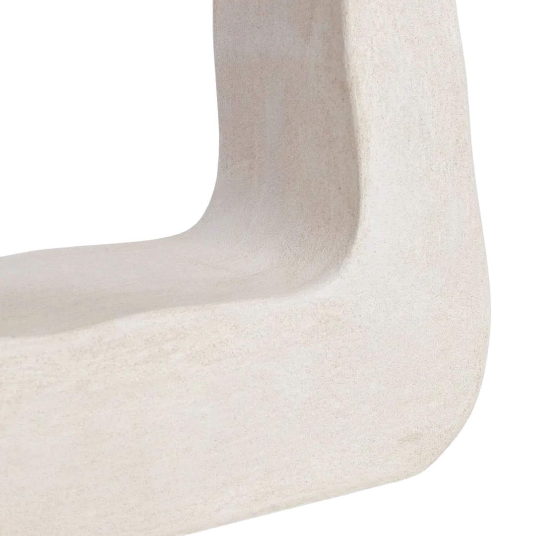 Close-up of sculpted base showing curved edges.