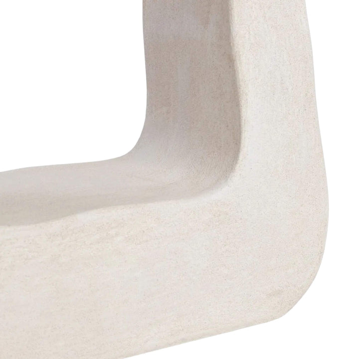 Close-up of sculpted base showing curved edges.