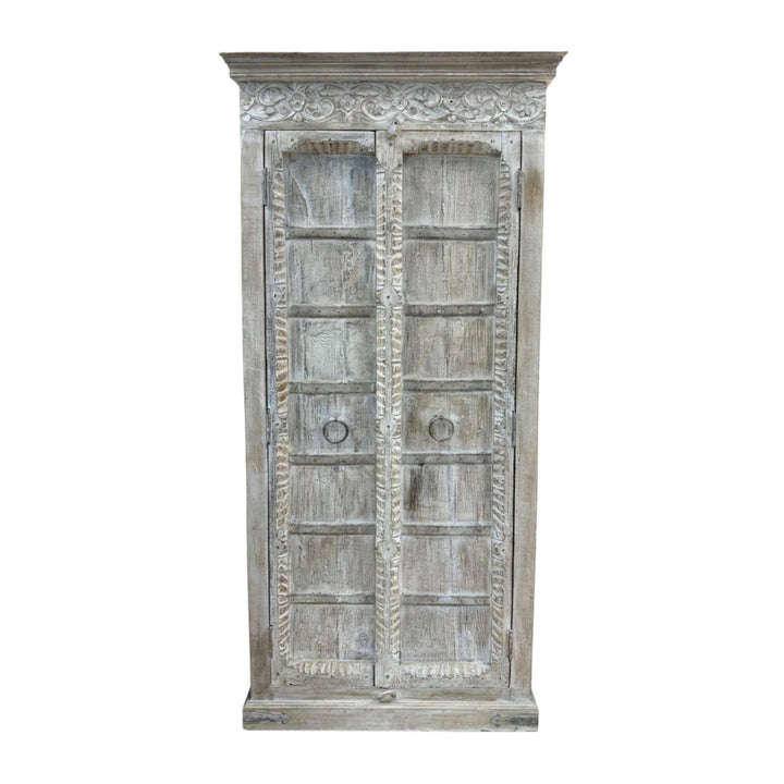 Front view of the Durga Wardrobe showcasing its tall silhouette and carved wooden doors.