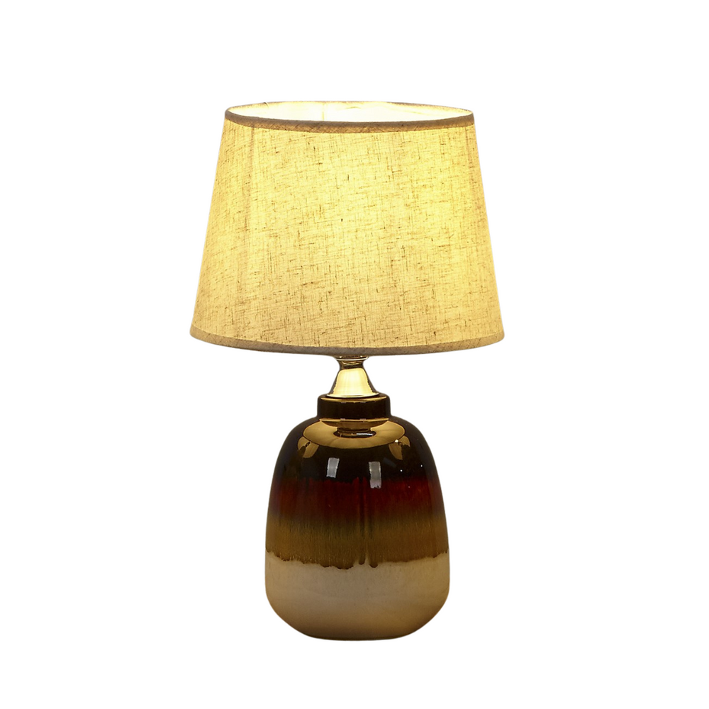 Side view of Earthenlight lamp showing warm glow from fabric shade.