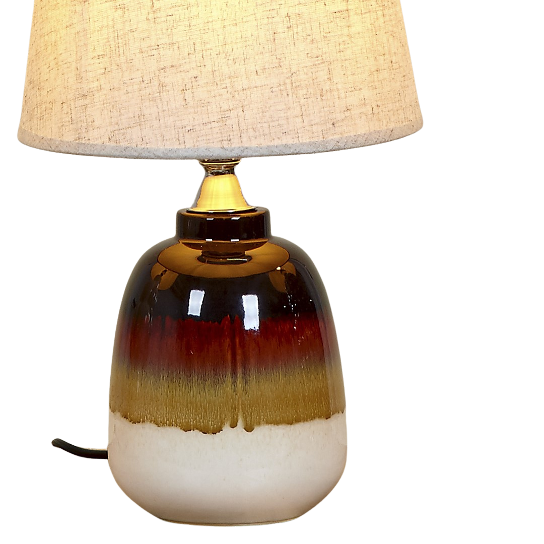 Close-up of porcelain lamp base with brown and cream gradient finish.