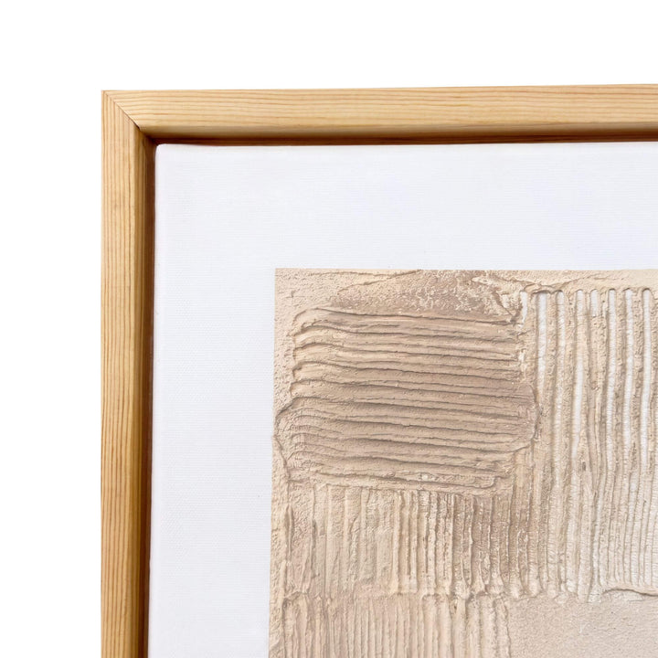 Close-up of the Earth Fragments painting highlighting the sculptural ivory surface and natural wood frame