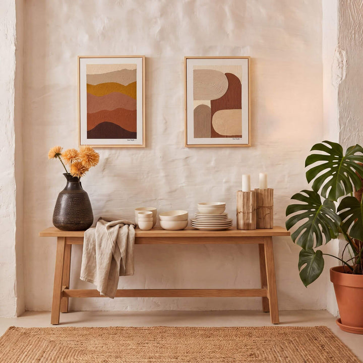 Earth Horizon painting displayed above a wooden console in a warm Mediterranean-inspired interior