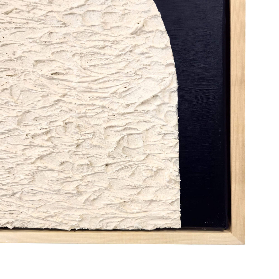 Close-up of the Eclipse artwork showing the textured ivory surface, black background, and natural wood frame