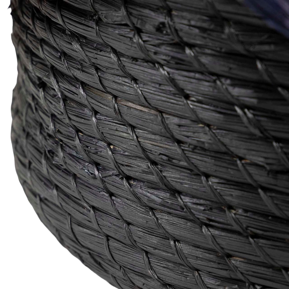 Close-up of the Eggun Basket showing the wave-like rim and woven detail.

