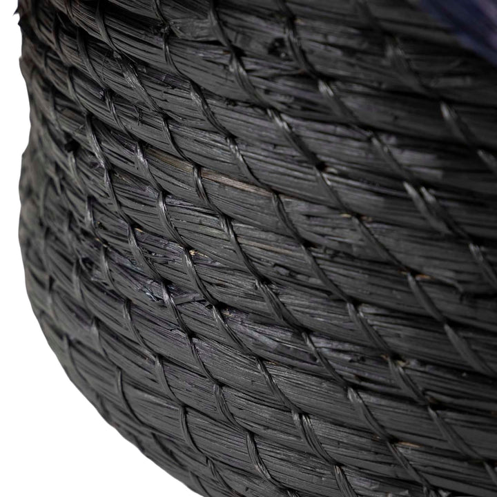 Close-up of the Eggun Basket showing the wave-like rim and woven detail.

