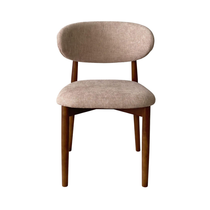 Front view of the Elara dining chair showing its curved upholstered backrest and cushioned seat