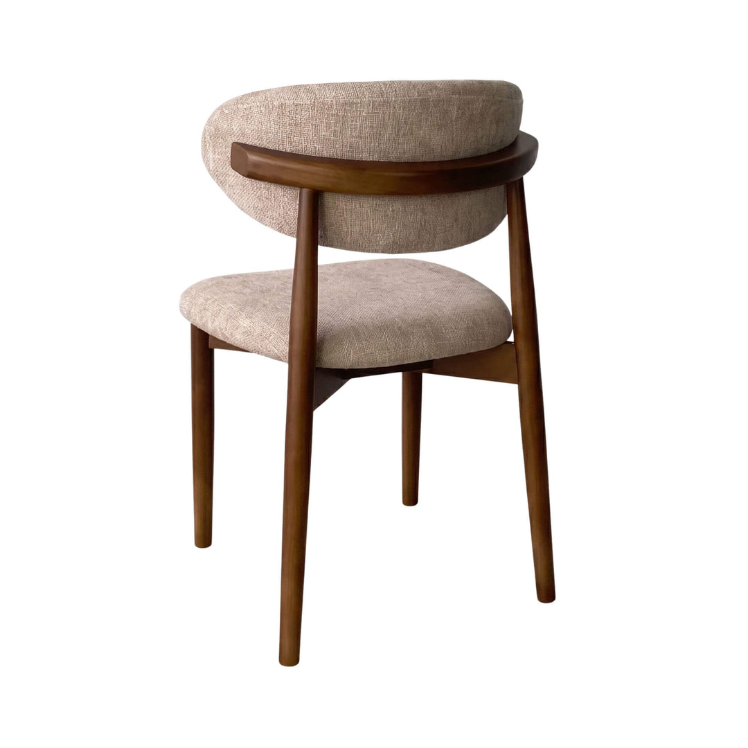 Rear angled view of the Elara chair highlighting the rounded walnut-toned wooden back support