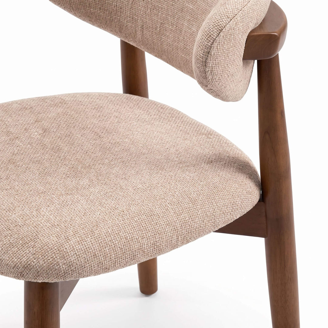 Close-up of the Elara dining chair showing the chenille upholstered seat and curved backrest